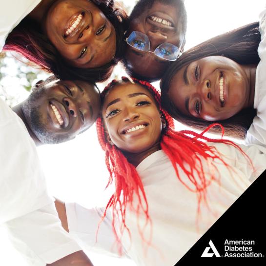 Smiling group of African American men and women forming a circle and looking down at camera