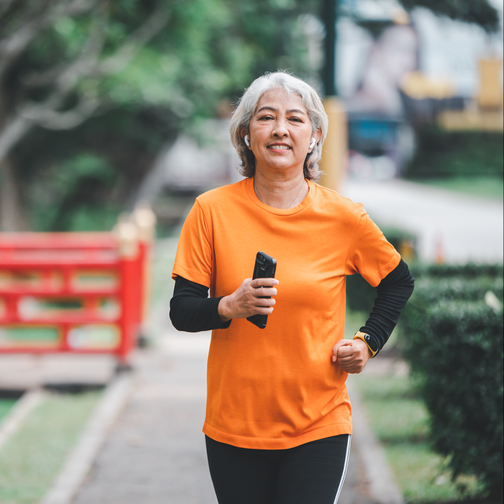 white haired elderly person exercising in the park