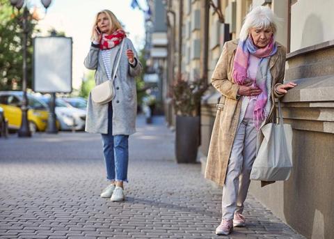 senior-woman-leaning-wall